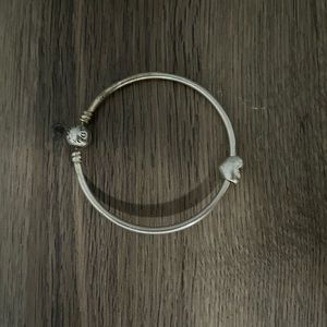 Silver pandora bracelet with heart charm.